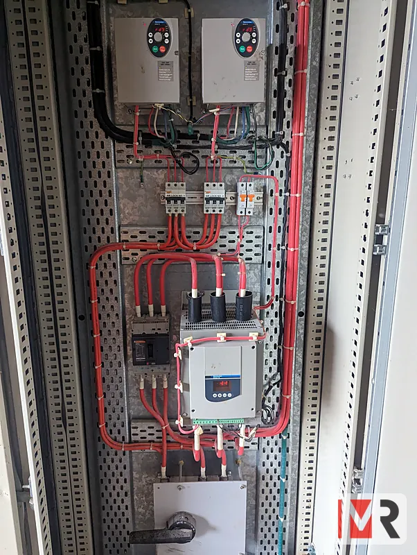 Switchboard with two variable speed drives and a soft starter, neatly laced red power wiring