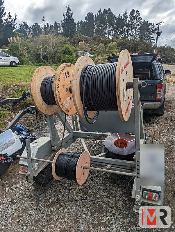 Cable drum trailer loaded with reels of power cable