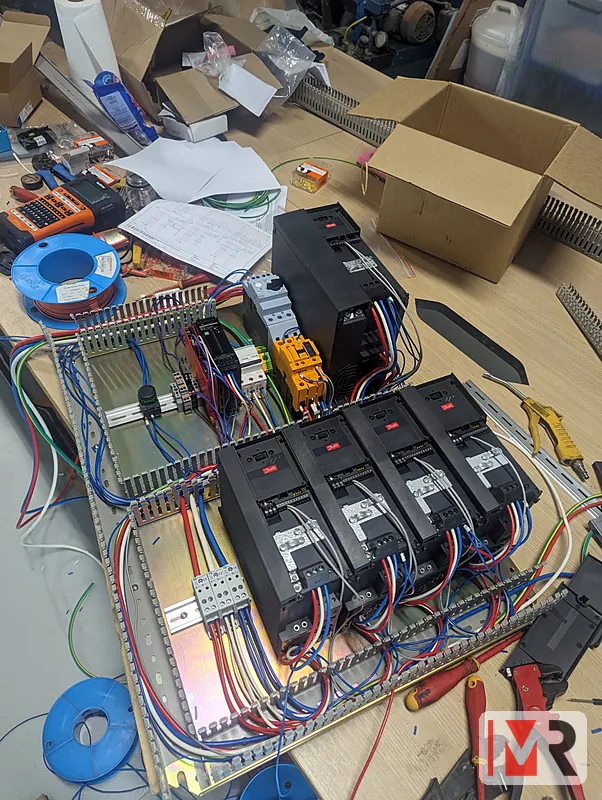 Four variable speed drives being wired on the workshop bench