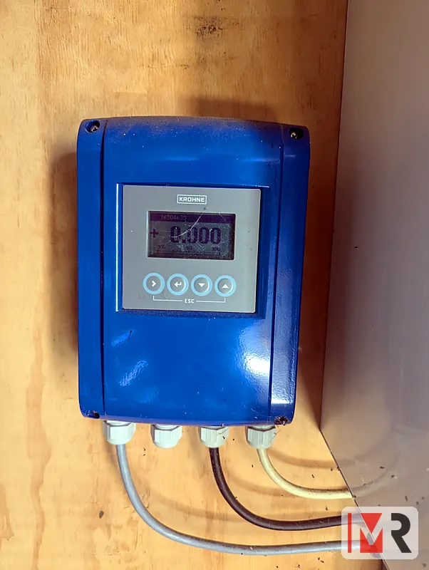 Magnetic flow meter display installed on a plywood wall