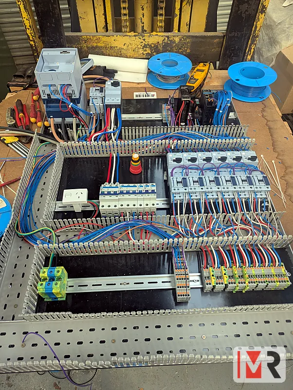 Control panel under construction with breakers, contactors and terminals