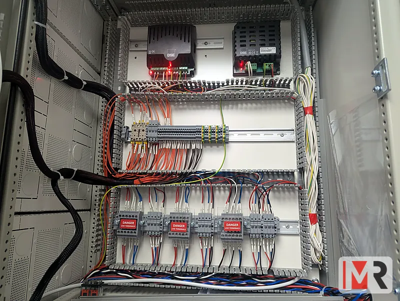 Inside a control panel: duct, relays and terminal wiring