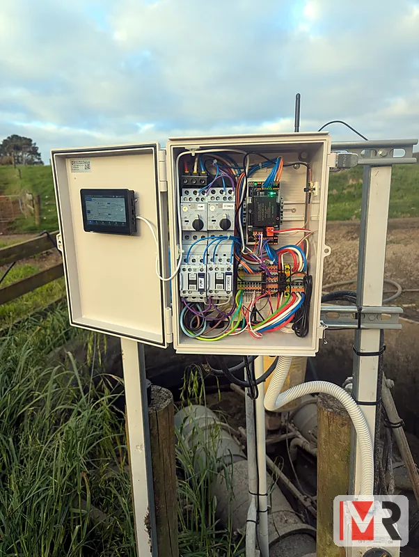 Modbee pump controller installed on a post beside farm pipework